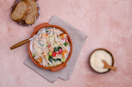 Traditional pasta with poultry and vegetables in a white sauce. Top view. Selective focus.