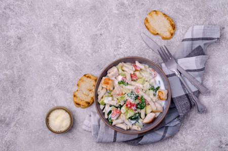 Traditional pasta with poultry and vegetables in a white sauce. Top view. Selective focus.の写真素材