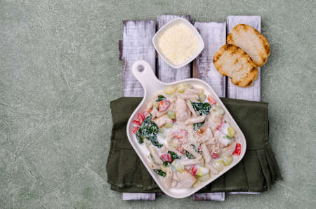 Traditional pasta with poultry and vegetables in a white sauce. Top view. Selective focus.の写真素材