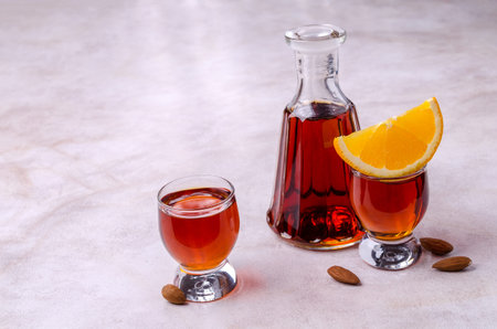 Transparent brown liquid in a glass on a light background. selective focus.の写真素材