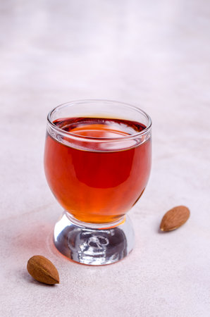 Transparent brown liquid in a glass on a light background. selective focus.の写真素材