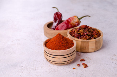 Crushed dry red pepper in a wooden dish. selective focus.