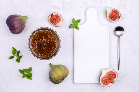 Jam figs in a glass jar on a light background. top view. selective focus.の写真素材