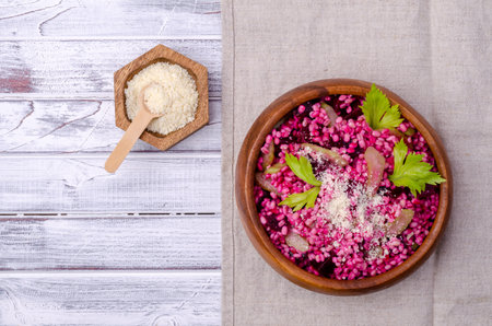 Pearl barley with vegetables and cheese on a light wooden background. top view.の写真素材