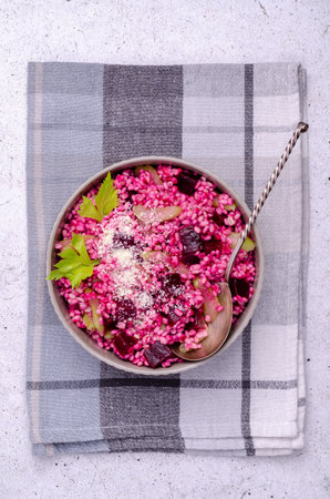 Pearl barley with vegetables and cheese on a light background. top view.の写真素材