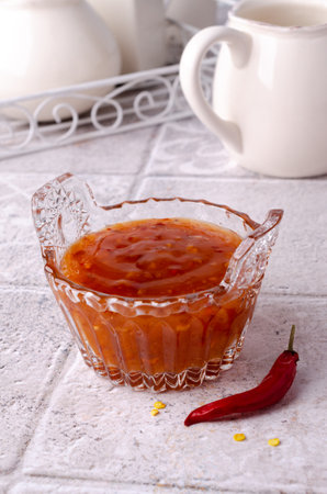 Traditional chili sauce in a glass on a light background. selective focus. copyspace.の写真素材