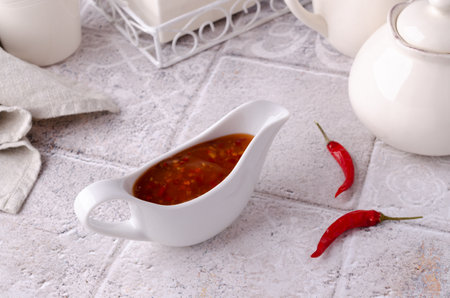 Traditional chili sauce in a ceramic on a light background. selective focus. copyspace.の写真素材