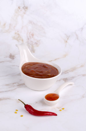 Traditional chili sauce in a ceramic on a light background. selective focus. copyspace.の写真素材