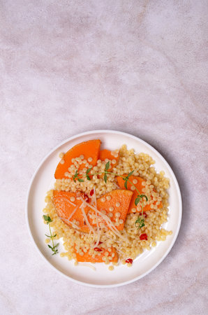 Pasta with fried pumpkin slices in a bowl on a light background. top view.の写真素材