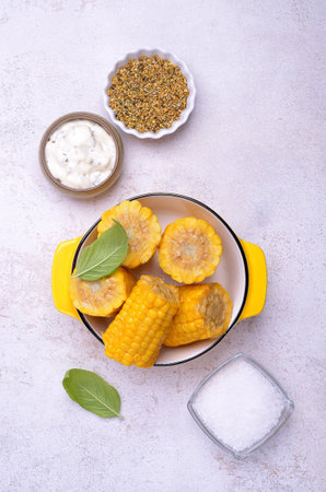 Chopped corn cobs in a ceramic dish on a light background. top view.の写真素材
