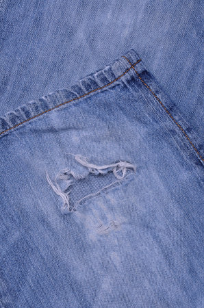 Background blue denim crumpled old fabric. Copy space. Top view.
