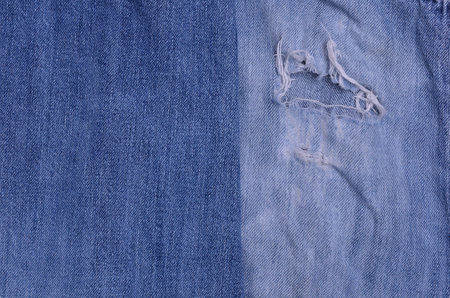 Background blue denim crumpled old fabric. Copy space. Top view.の写真素材
