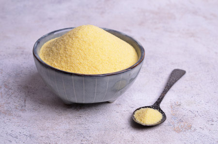 Durum wheat flour in a ceramic bowl on a light background. Selective focus.の写真素材
