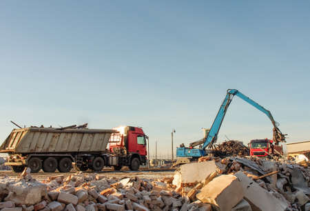 loading scrap metal and debris onto a truckの写真素材