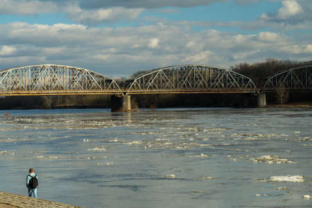 A sunny boulevard, a walk with a loved one, a river and a bridge in the distanceの写真素材