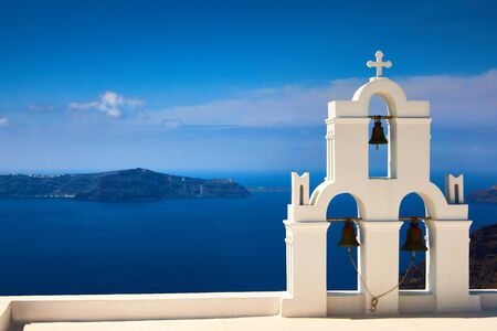 Oia town on Santorini island, Greece. Traditional and famous houses and churches with blue domes over the Caldera, Aegean sea. Oia village in the morning light, Santorini. Amazing sunrise view with white houses in Oia village.の写真素材