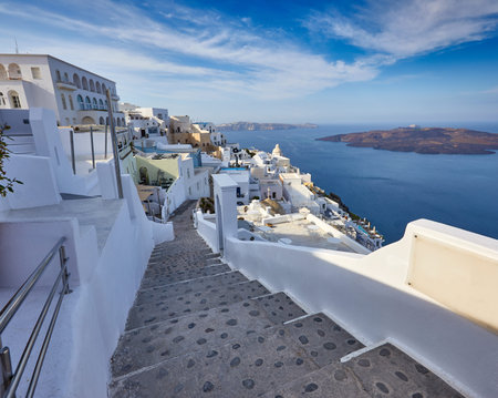 Fira town on Santorini island, Greece. Incredibly romantic sunrise on Santorini. Oia village in the...