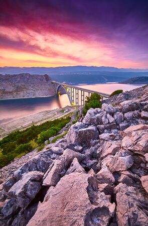 Dramatic summer seascape of Adriatic sea. Bigger arch Bridge to Krk Island at sunrise, near Maslenica, Croatia, Europe.  Bridge connects the Croatian island of Krk with the mainland. Morning light. の写真素材