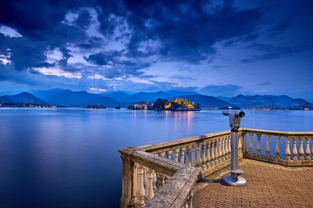 View of Lago Maggiore, Stresa Italy, Europe. Isola Superiore o dei Pescatori. Isola Bella. Viewpoint. Evening on Borromean Islands. Switzerland at twilight. Laveno Mombello town. North of Italy.の写真素材