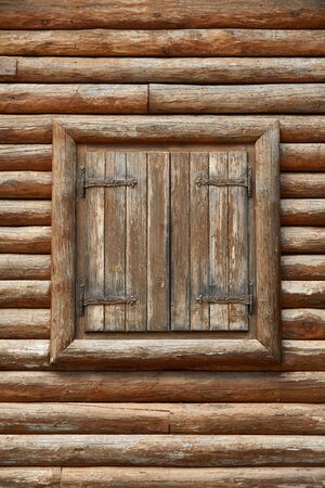 Wooden window with shutters. A bunch of wooden window shutters pattern on wooden wall. Restaurant cafe warehouse decor. Naked worn wooden and plain painted shutters. Hipster loft wallpaperの写真素材