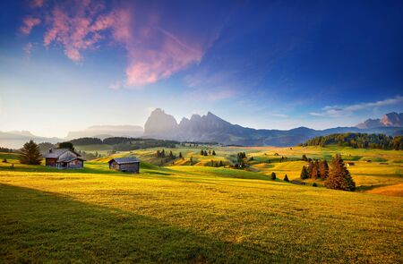 Wonderful summer view of Dolomiti Alps. Attractive morning scene of Compaccio village, Seiser Alm or Alpe di Siusi location, Bolzano province, South Tyrol, Italy, Europe. Dolomiti hillsの写真素材
