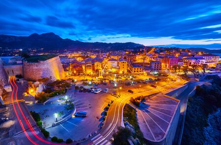 View from the walls of the citadel of Calvi on the old town with historic buildings at evening sunset. Bay with yachts and boats. Luxurious marina and very popular tourist destination. Corsica, Franceの写真素材