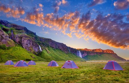 Camping tents near Seljalandsfoss. One of the most beautiful waterfalls on the Iceland, Europe. Popular and famous tourist attraction summer holiday destination in on South Iceland. Travel postcardの写真素材
