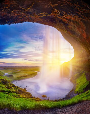 Incredible sunset on Seljalandsfoss. One of the most beautiful waterfalls on the Iceland, Europe. Popular and famous tourist attraction summer holiday destination in on South Iceland. Travel postcardの写真素材