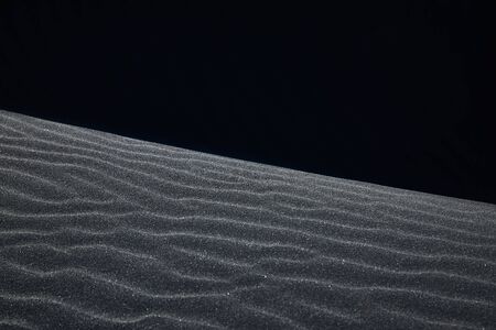 Black Icelandic Basalt Sand. Embossed sandy texture. Wavy background. Abstract pattern. Nature design. Reynisfjara beach with black volcanic sand. Stokksnes dunes. Reynisdrangar, Vik, Iceland Europeの写真素材