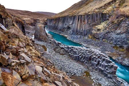 Studlagil basalt canyon, Jokulsa a Dal River. Iceland, Europe.  One of the most wonderfull hidden place and nature sightseeing. Famous tourist landscape with basalt rock formations. Travel postcard.の写真素材