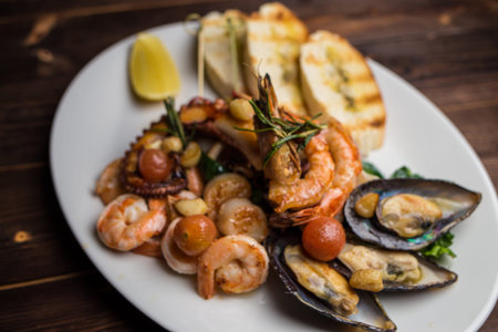 set of different seafood includes shrimp, mussels, squid and octopusの写真素材