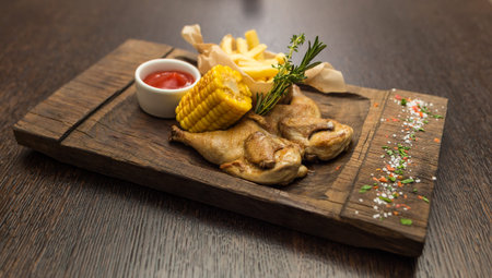 grilled chicken with fries and boiled cornの写真素材