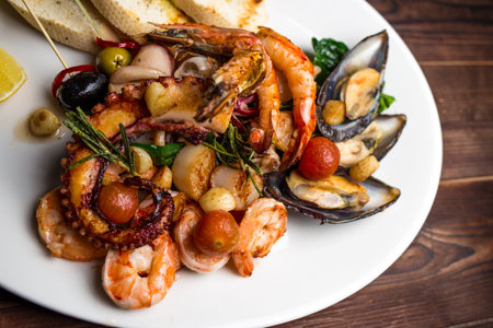 set of different seafood includes shrimp, mussels, squid and octopusの写真素材