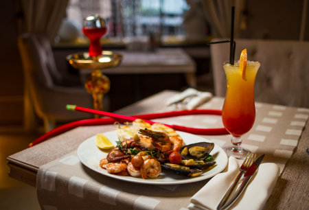 Relaxing table in a restaurant with seafood and hookahの写真素材