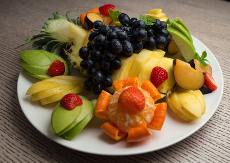slices of fresh fruit with grapes and pineappleの写真素材