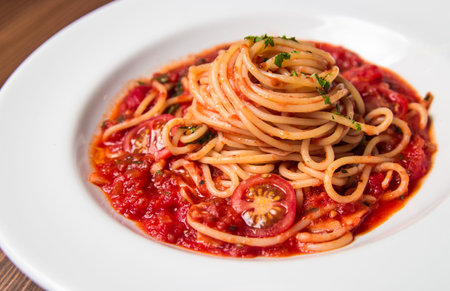 Spaghetti in tomato sauce with cherry tomatoesの写真素材