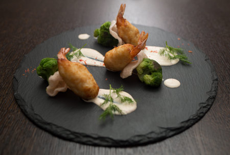 crab cakes with shrimp tails and chipsの写真素材