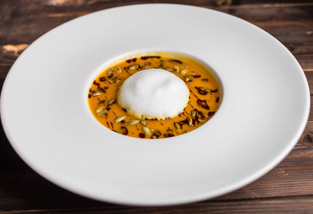 pumpkin soup with air foam and pumpkin seedsの写真素材