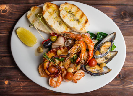 set of different seafood includes shrimp, mussels, squid and octopusの写真素材