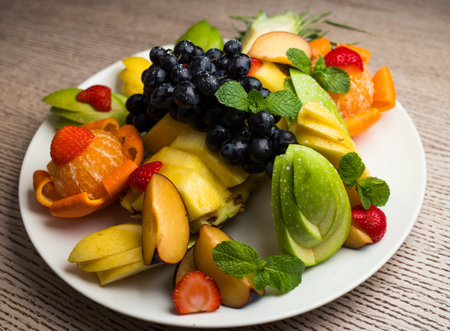 slices of fresh fruit with grapes and pineappleの写真素材