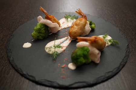 crab cakes with shrimp tails and chipsの写真素材