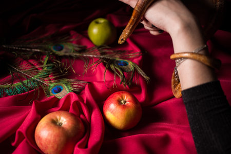 The snake in the witch's hands over poisoned applesの写真素材