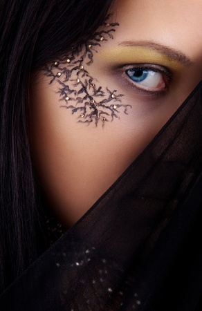 Image blue-eyed girl with drawing on the faceの写真素材