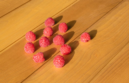 raspberries on wooden white washed background