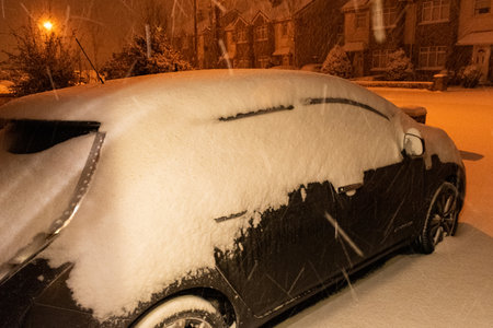 Car almost totally buried under a snow after a blizzard .の写真素材