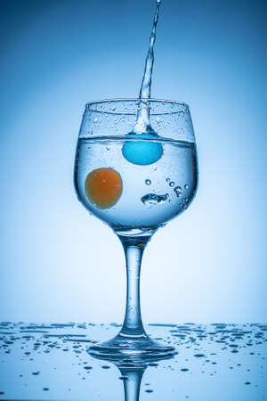 Colored ice balls droped into coctail glass .の写真素材