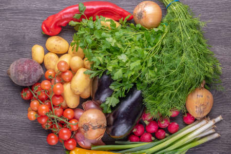Fresh colorful organic vegetables on a rustic wooden table background.の写真素材