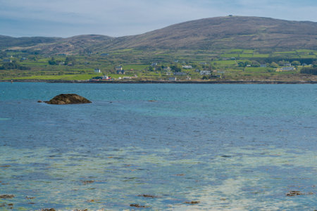 View over water from Castletown Bere to Bere island in the south of Ireland and the mountains at the background.の写真素材
