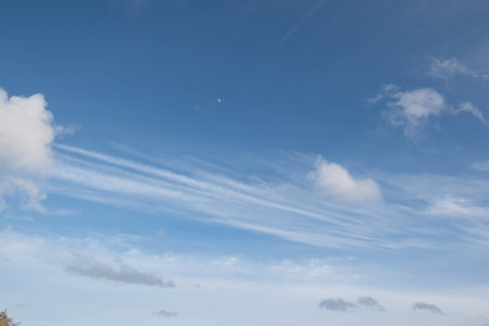 Blue sky with some fluffy clouds background
