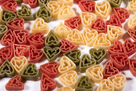 Food background ,Italian three color heart shaped pasta .の写真素材